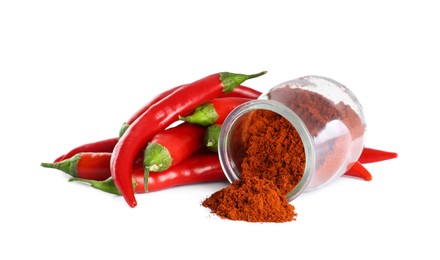 Photo of Fresh chili peppers and jar of paprika powder on white background