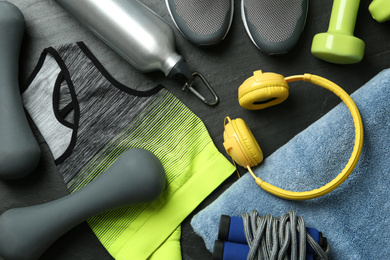 Photo of Set of fitness equipment and accessories on black background, flat lay