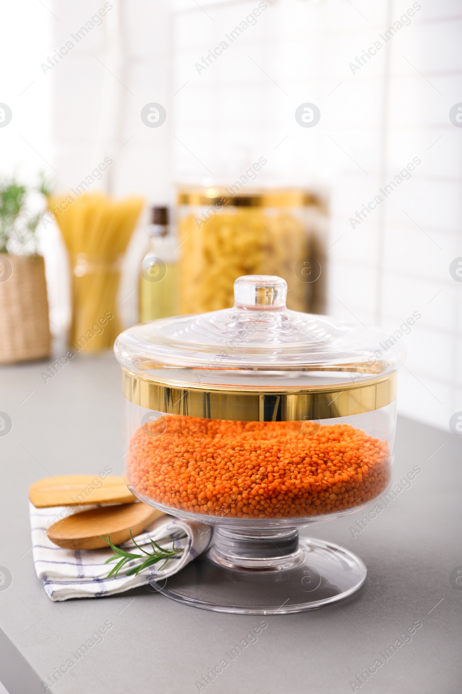 Photo of Red lentil in modern kitchen glass container on table