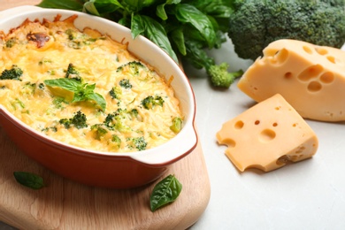 Photo of Tasty broccoli casserole in baking dish on table