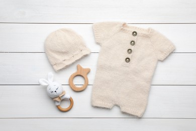 Photo of Flat lay composition with child's clothes and accessories on white wooden table