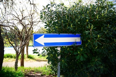 Photo of Road sign One Way Traffic near green plant outdoors