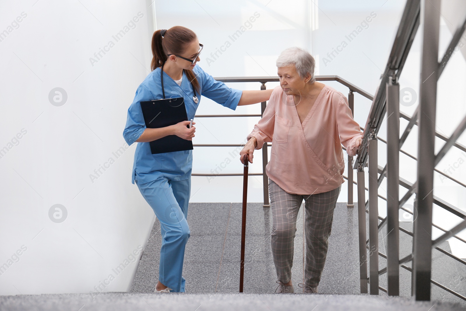 Photo of Doctor helping senior patient in modern hospital