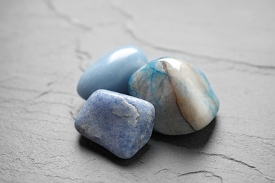 Beautiful natural blue gemstones on grey table