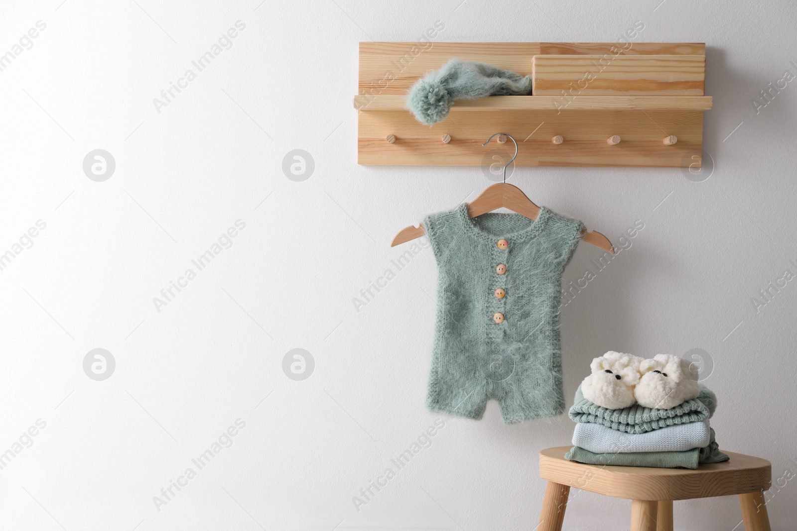 Photo of Cute children's clothes and shoes in room. Space for text