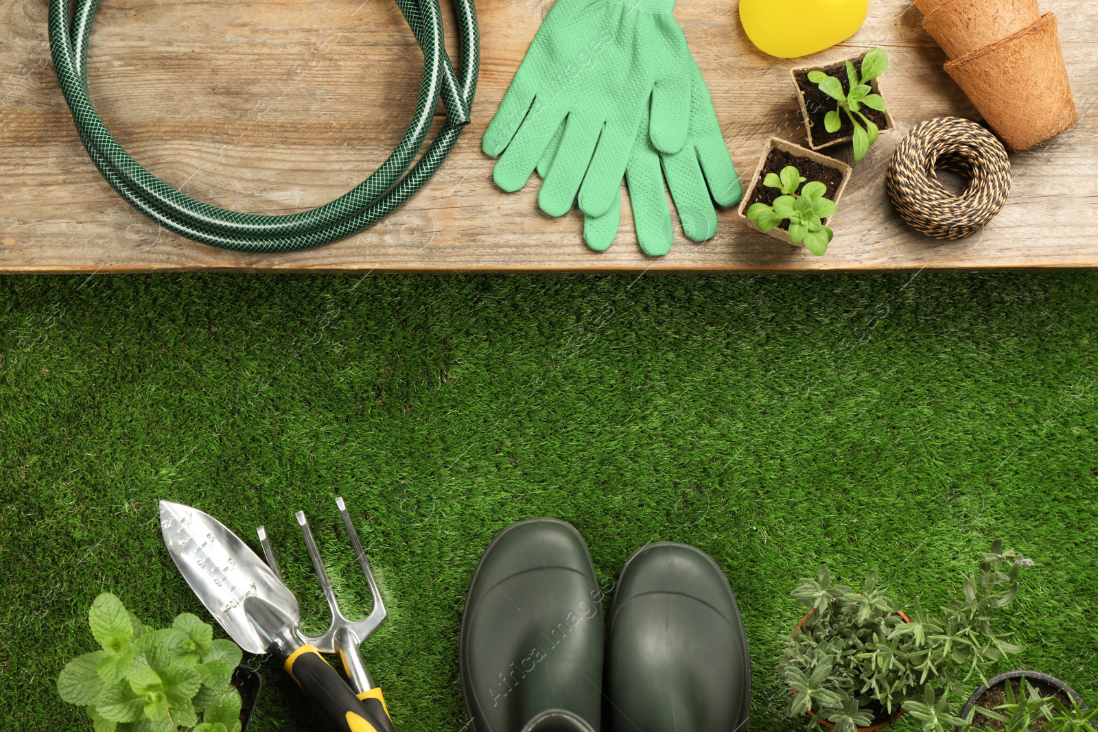 Photo of Flat lay composition with gardening tools and plants on green grass, space for text