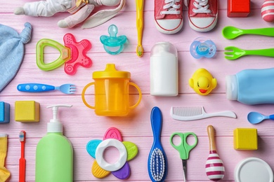 Photo of Flat lay composition with baby accessories and toys on color background