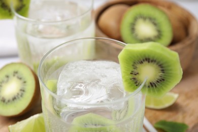 Photo of Refreshing drink with kiwi on table, closeup