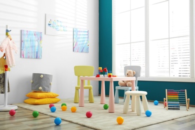 Baby room interior with color furniture and toys