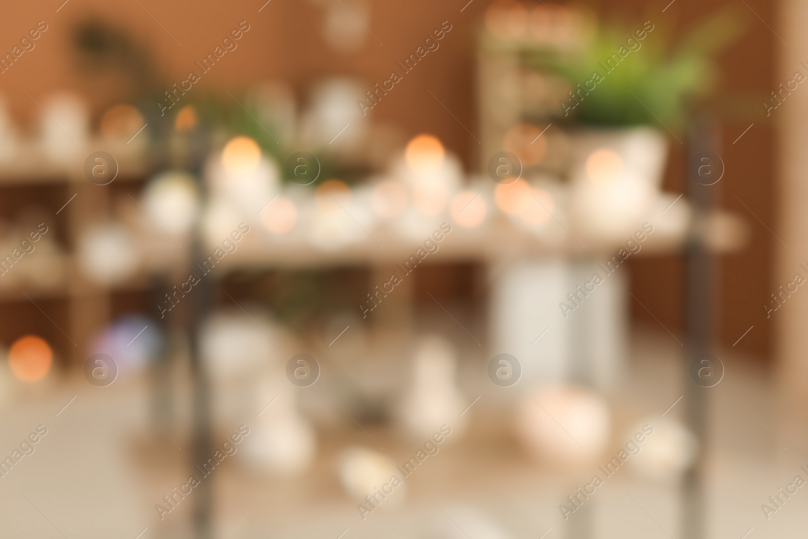 Photo of Blurred view of spa salon interior with candles