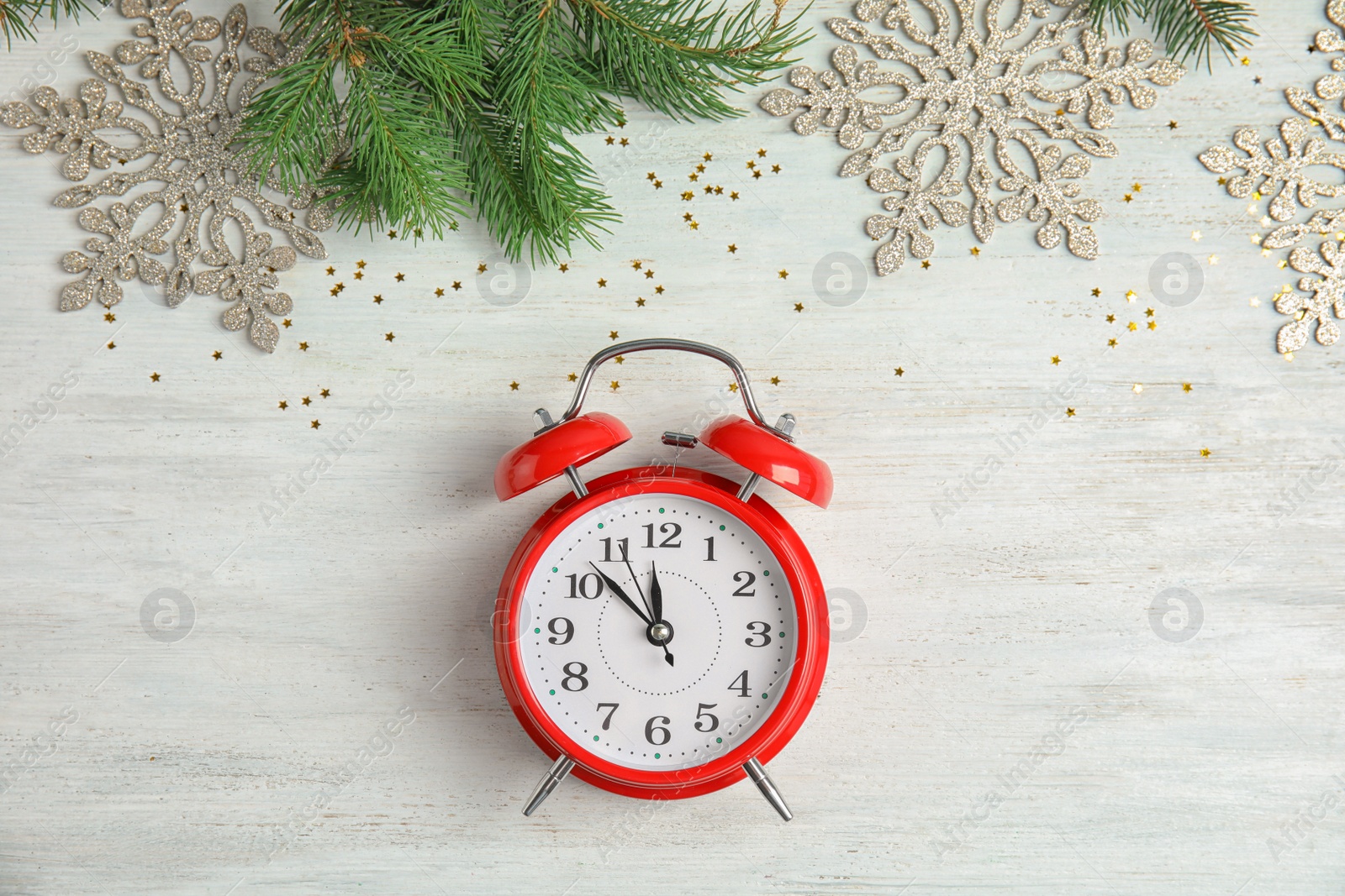 Photo of Flat lay composition with clock and decorations on wooden background. Christmas countdown