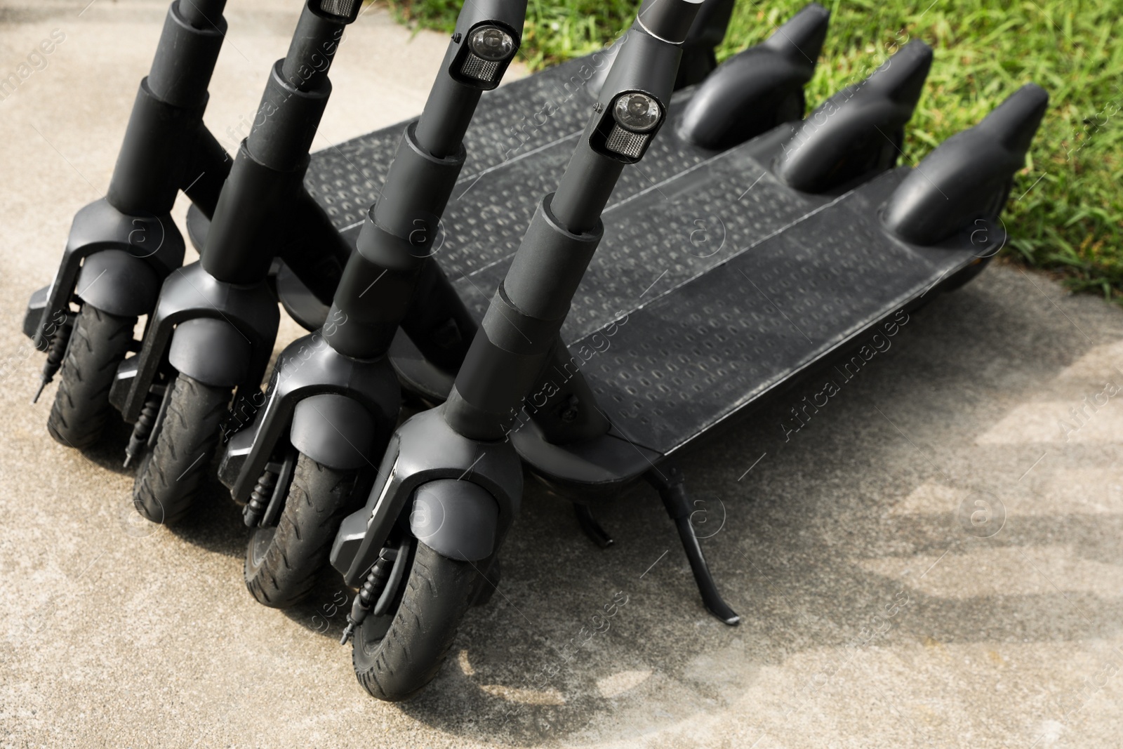 Photo of Row of electric scooters outdoors, closeup. Rental service