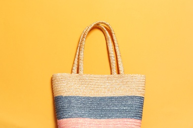 Stylish bag on color background, top view. Beach accessories