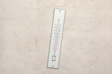 Photo of Weather thermometer on light background, top view