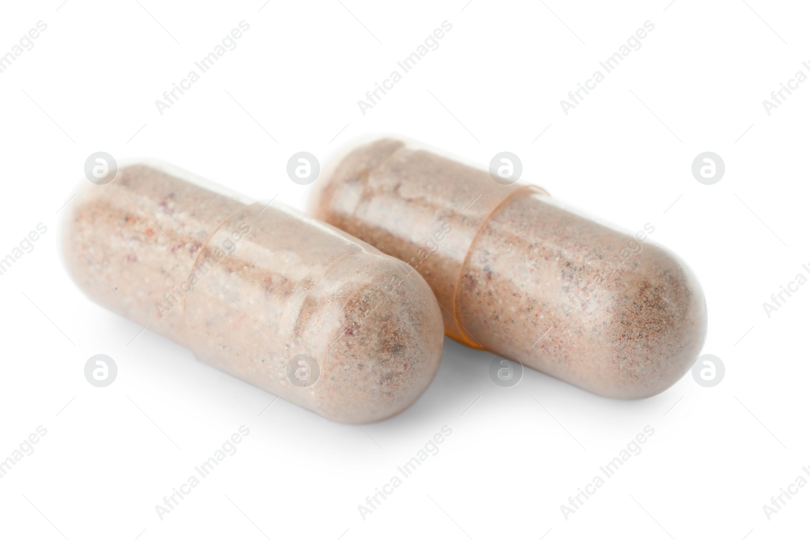 Photo of Two transparent gelatin capsules on white background, closeup