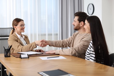 Photo of Lawyer shaking hands with clients in office