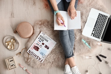 Photo of Female beauty blogger with notebook and laptop indoors, top view