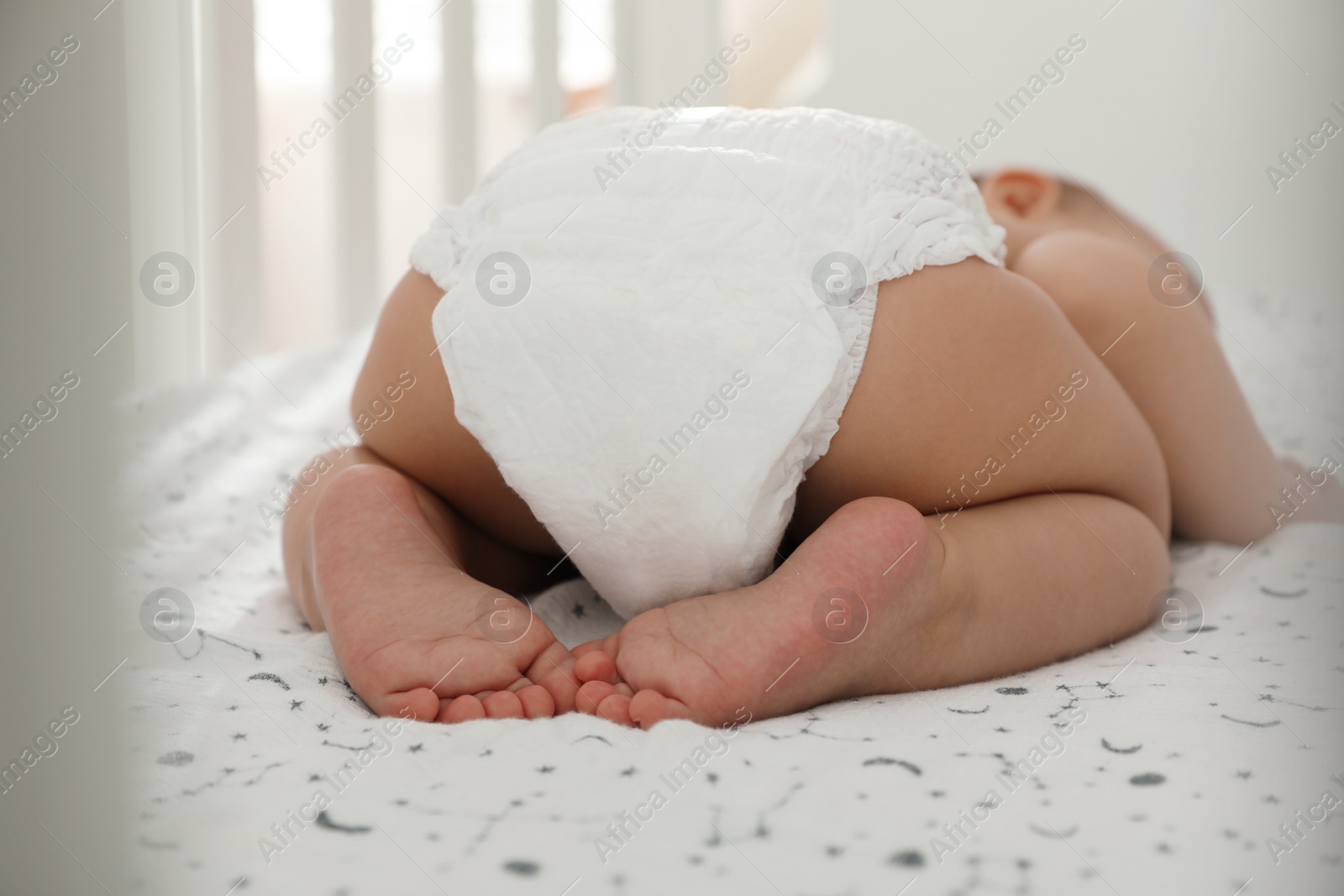 Photo of Cute little baby sleeping in crib, closeup