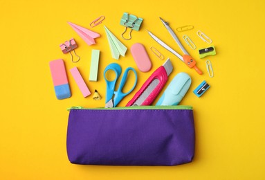Photo of Flat lay composition with different school stationery on yellow background. Back to school