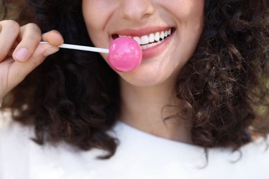 Photo of Woman with tasty pink lollipop, closeup view