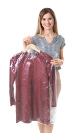 Photo of Young woman holding hanger with dress in plastic bag on white background. Dry-cleaning service