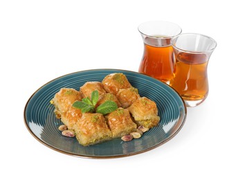 Photo of Delicious baklava with pistachios and hot tea on white background