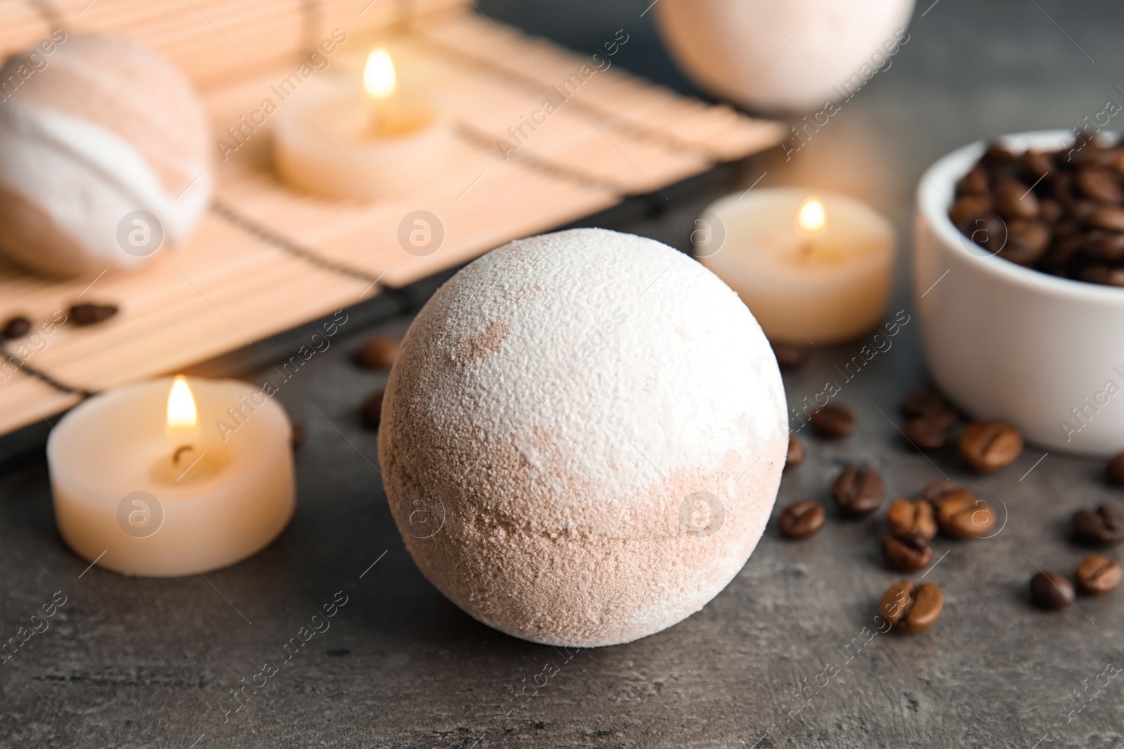 Photo of Bath bomb, coffee beans and candles on table, closeup