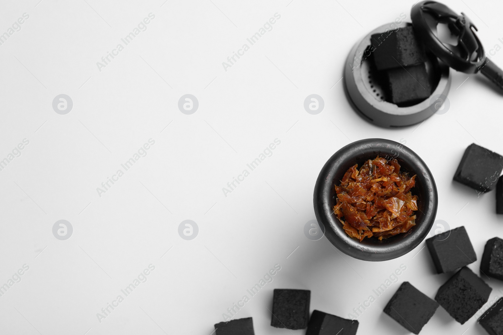 Photo of Hookah parts with tobacco and charcoals on white background, top view