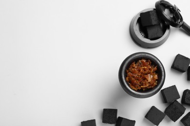 Hookah parts with tobacco and charcoals on white background, top view