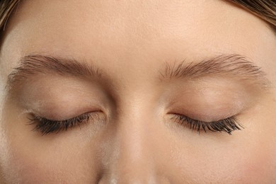 Photo of Woman with long eyelashes after mascara applying, closeup