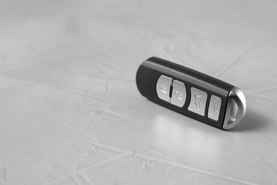 Photo of Remote car key on grey background. Space for text