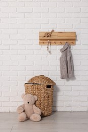 Photo of Beautiful children's room with white brick wall and toys. Interior design