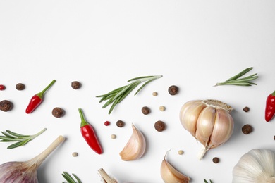 Photo of Composition with garlic, rosemary and peppers on white background, top view. Space for text
