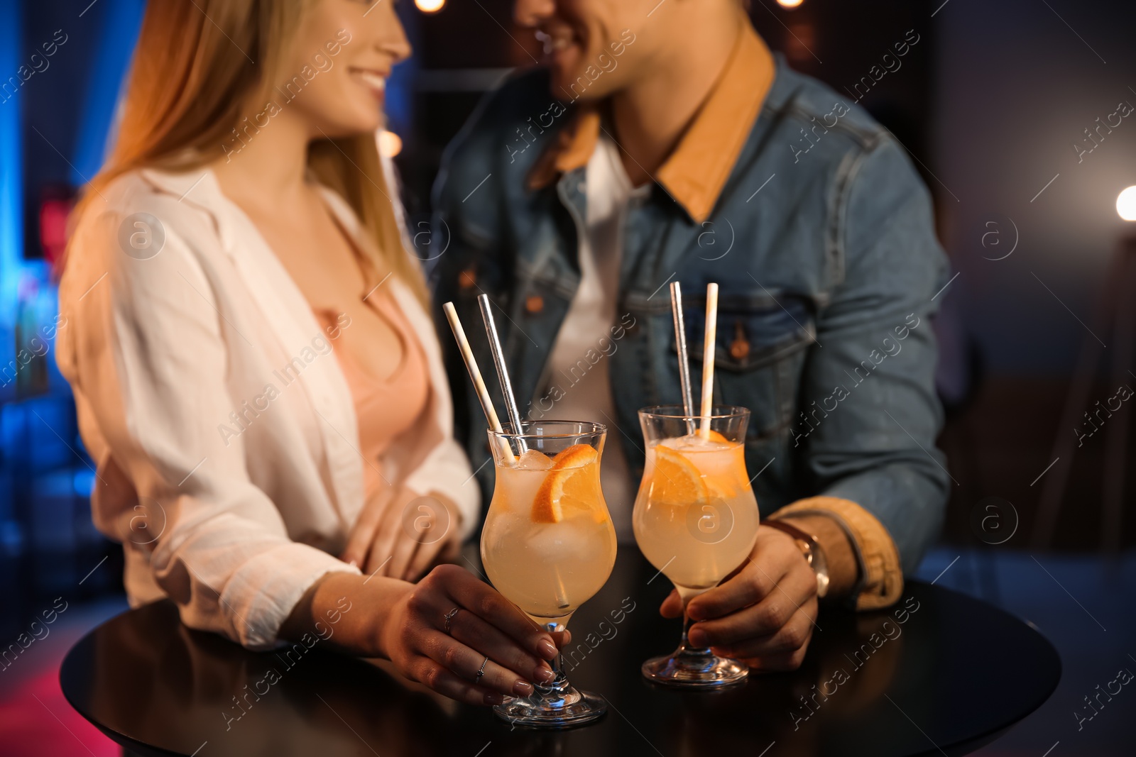 Photo of Man and woman flirting with each other in bar, closeup