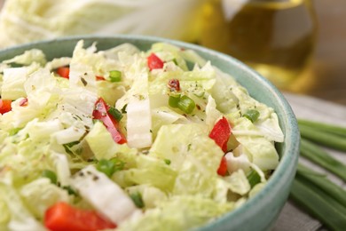 Photo of Tasty salad with Chinese cabbage in bowl on table, closeup