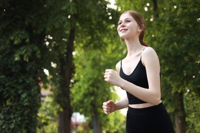 Photo of Teenage girl running outdoors in morning, space for text
