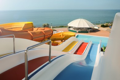 Colorful slides in water park on sunny day