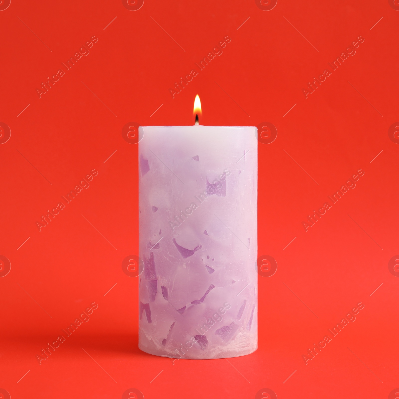 Photo of Alight scented wax candle on color background