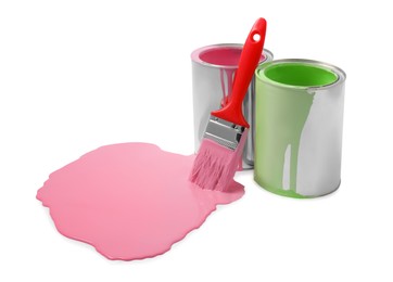 Photo of Spilled pink paint, brush and cans on white background