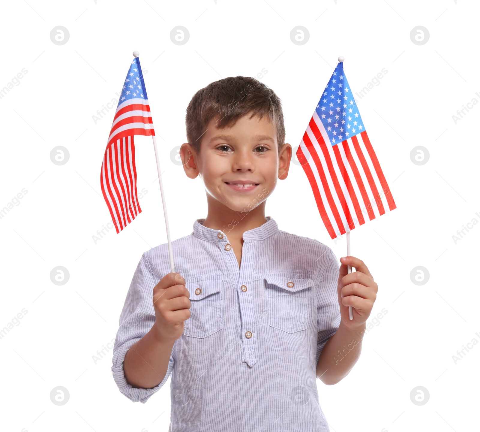 Photo of Portrait of cute little boy with American flags on white background