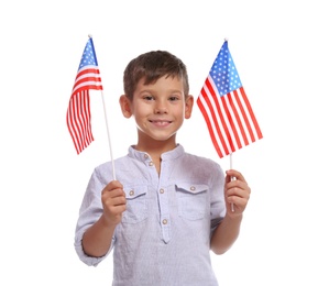 Photo of Portrait of cute little boy with American flags on white background
