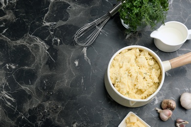 Flat lay composition with tasty mashed potato and space for text on dark table