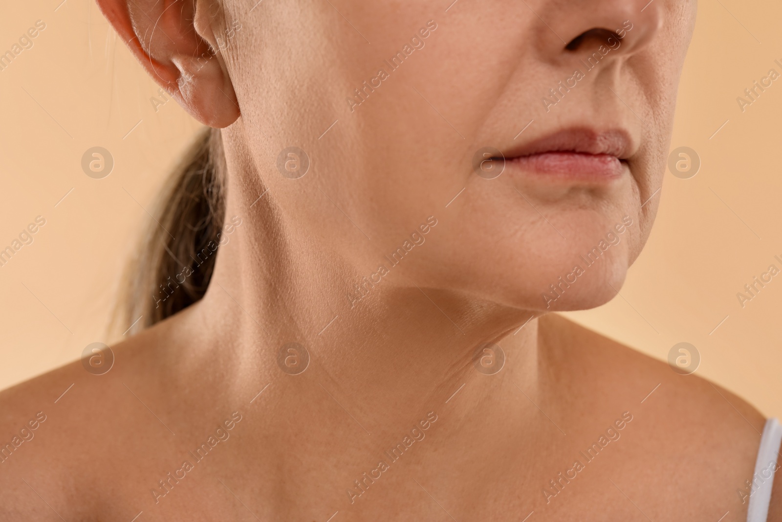 Photo of Woman with normal skin on beige background, macro view