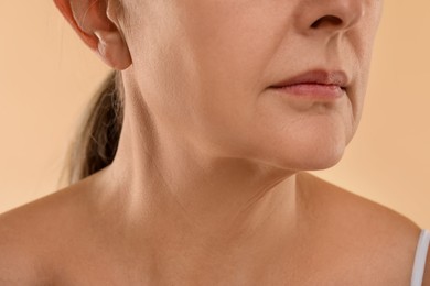 Woman with normal skin on beige background, macro view