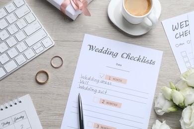 Photo of Flat lay composition with Wedding Checklist on wooden table