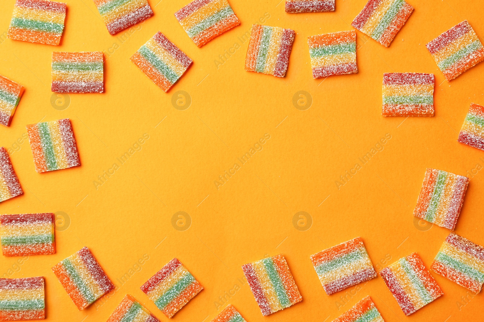 Photo of Flat lay composition with delicious jelly candies on color background. Space for text