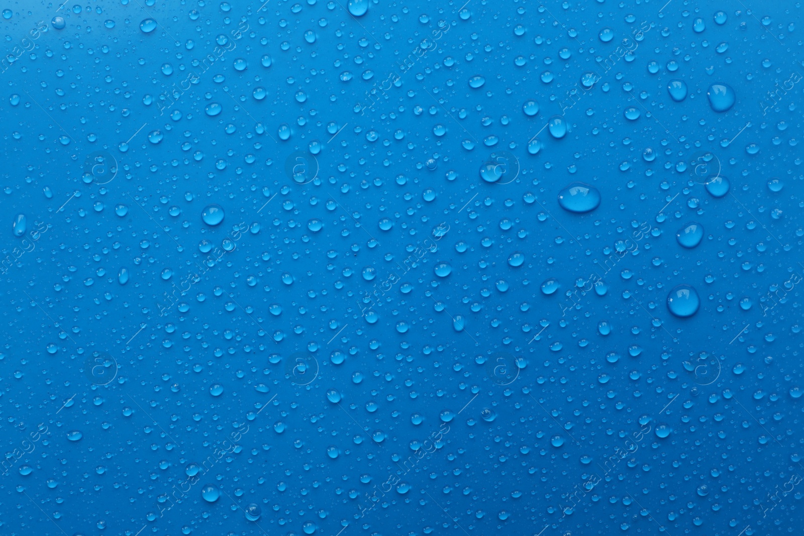 Photo of Water drops on light blue background, top view