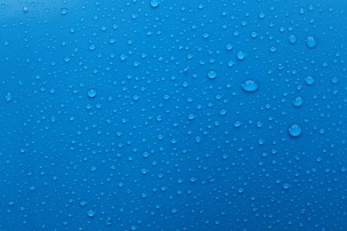 Photo of Water drops on light blue background, top view