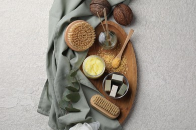 Photo of Composition with different spa products and reed air freshener on light grey textured table, top view