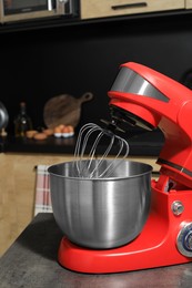 Photo of Modern stand mixer on grey table in kitchen